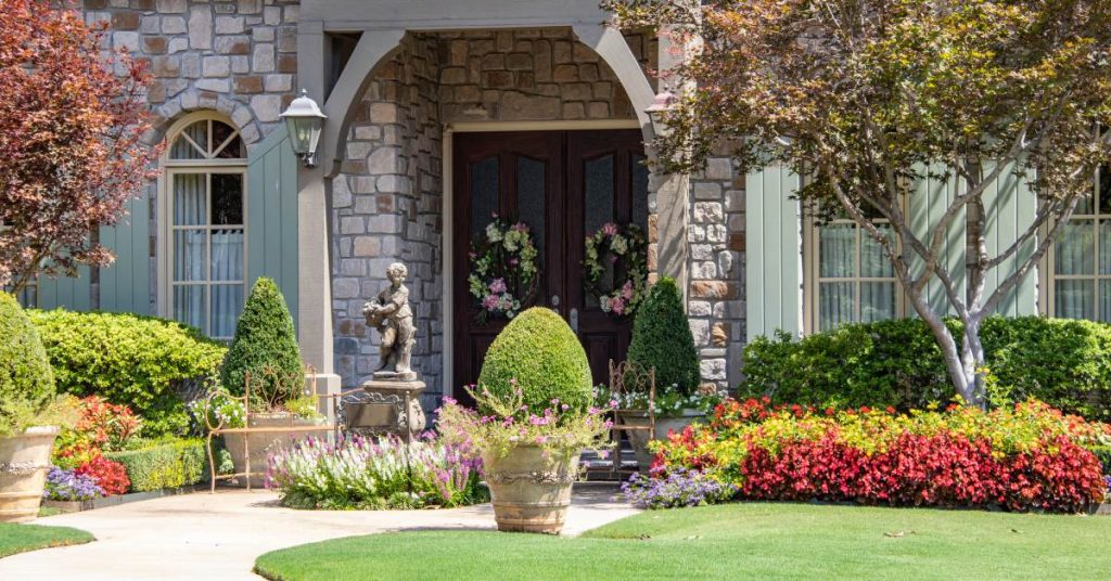 An upscale residential home’s well-designed and maintained front entrance, complete with quality hardscaping and landscaping.