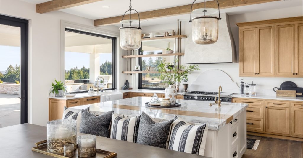 A rustic residential home interior. The kitchen and dining room are defined by faux wood beams on the ceiling.